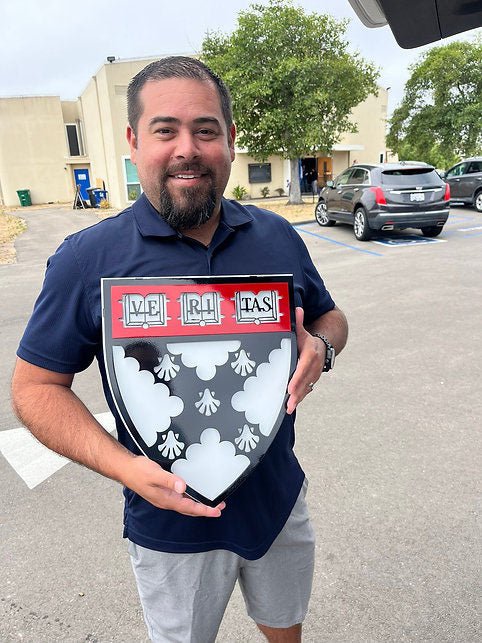 Recipient holding a personalized Veritas shield, Harvard Business Solutions by IRONiNK.
