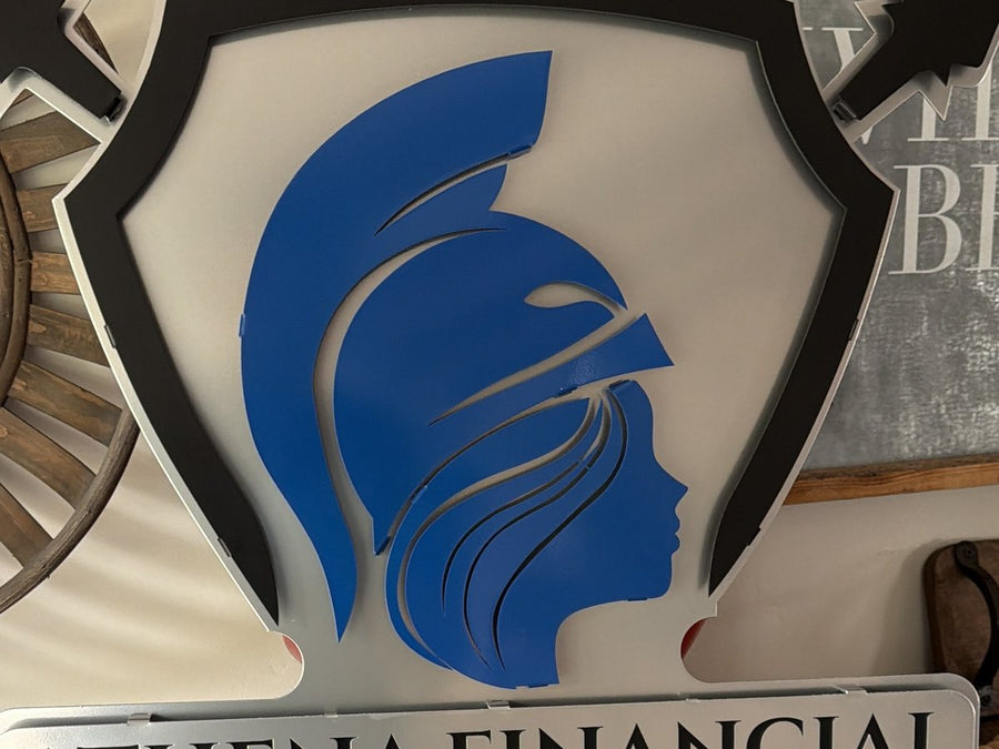 Close-up of a layered metal shield sign with a blue helmeted figure for Athena Financial and Insurance Associates