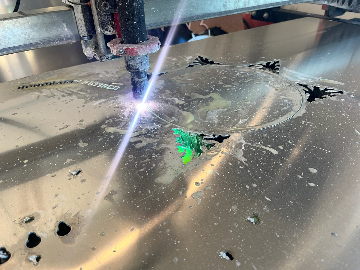 Plasma cutter cutting a sheet of aluminum in the IRONiNK shop