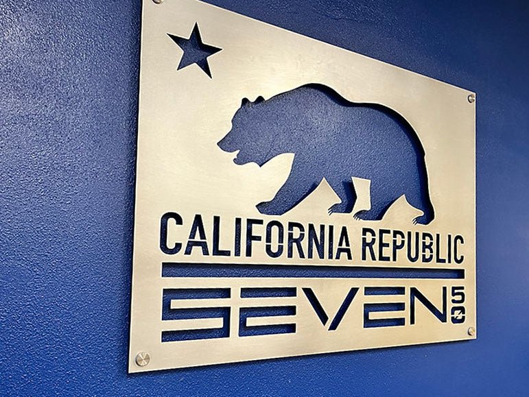 Metal area sign mounted on a blue wall, Area Bear by IRONiNK.