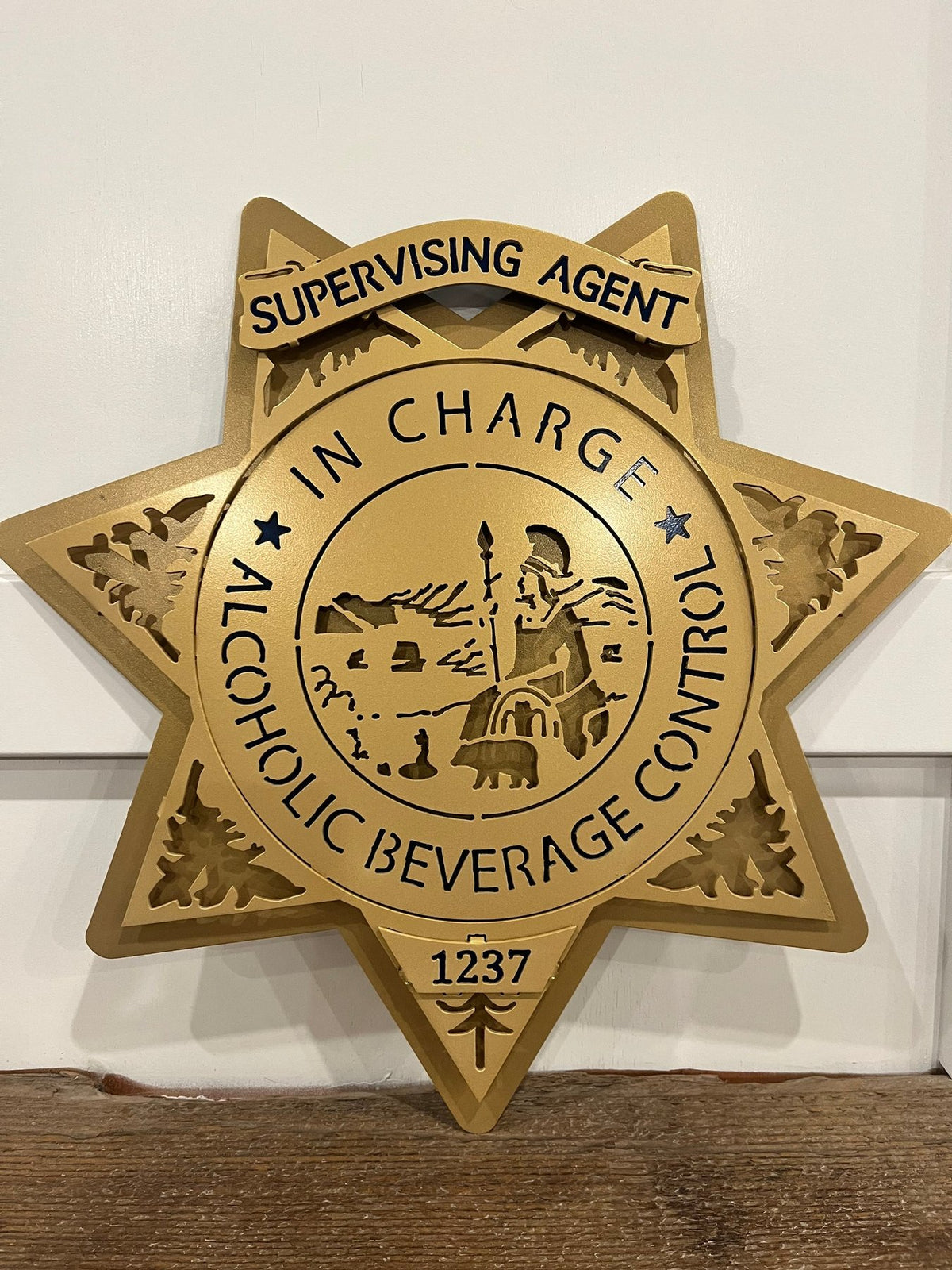 Close-up of agent in charge lettering, California ABC Investigations by IRONiNK.