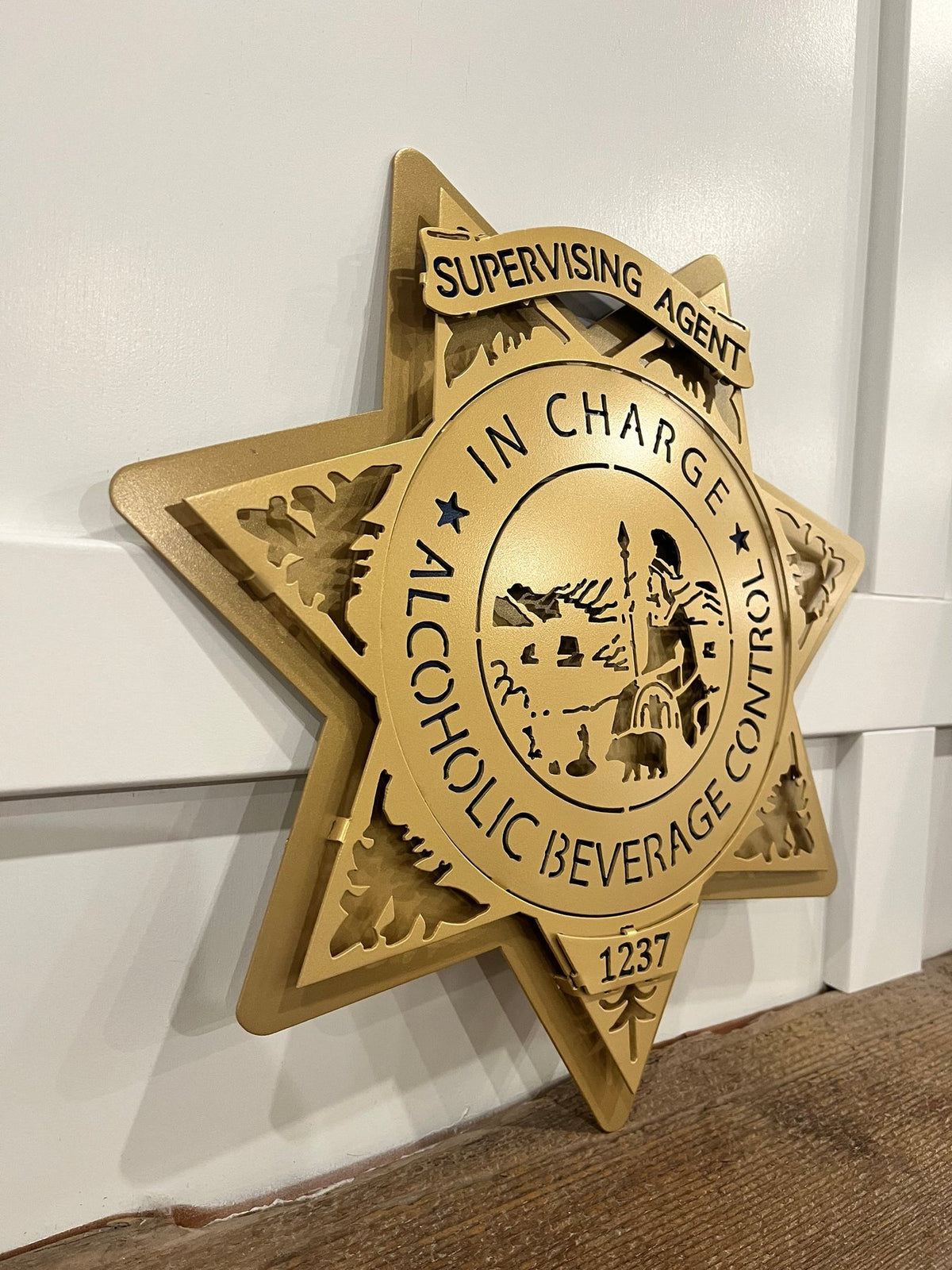Gold supervising agent star on a wooden shelf, California ABC Investigations by IRONiNK.