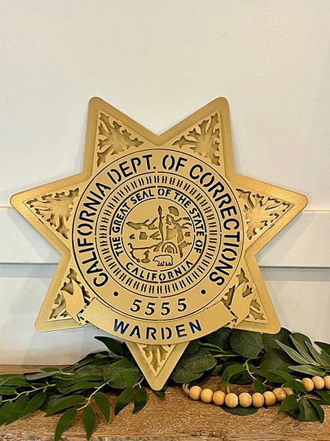 Gold warden star displayed with greenery, California Department of Corrections Star by IRONiNK.
