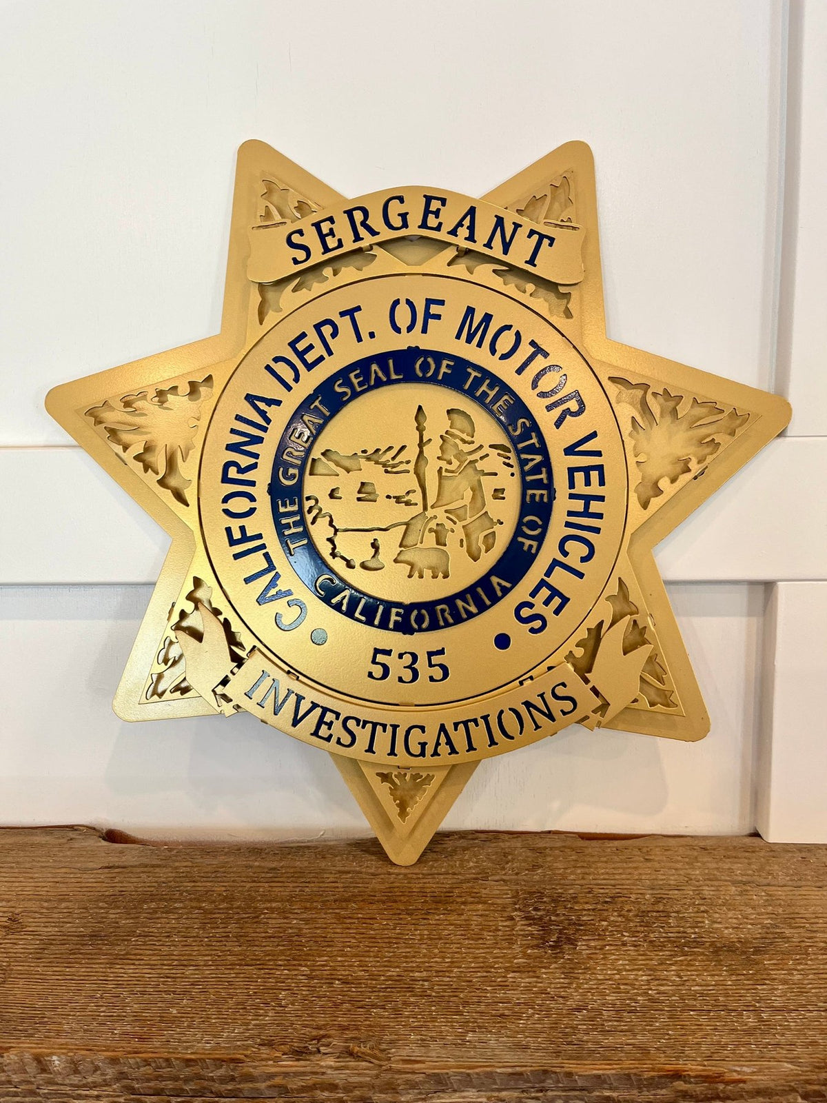 Gold sergeant star displayed on a shelf, California DMV Investigations by IRONiNK.