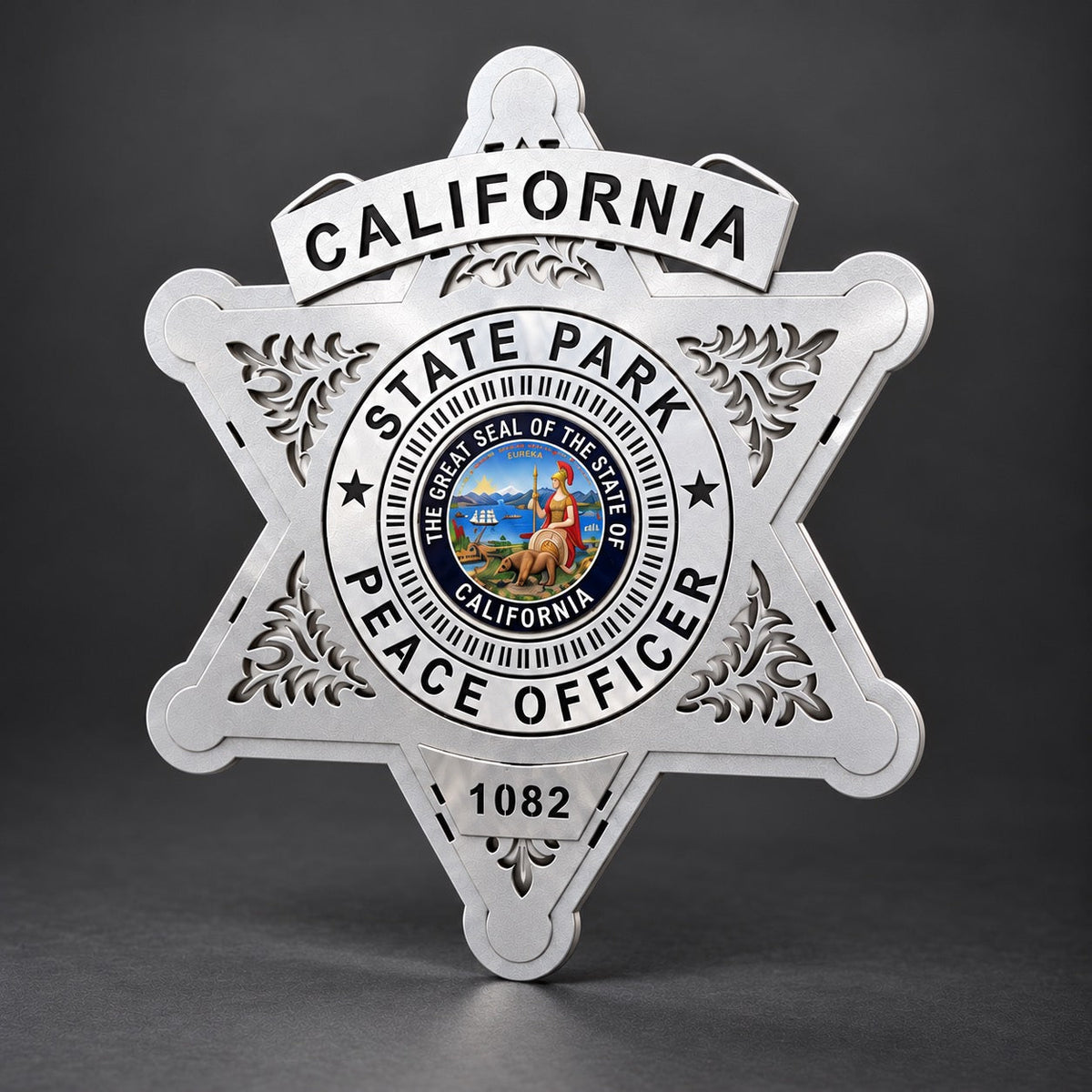 Angled view of the California State Parks Peace Officer star showing its layered silver aluminum construction and cut-out scrollwork