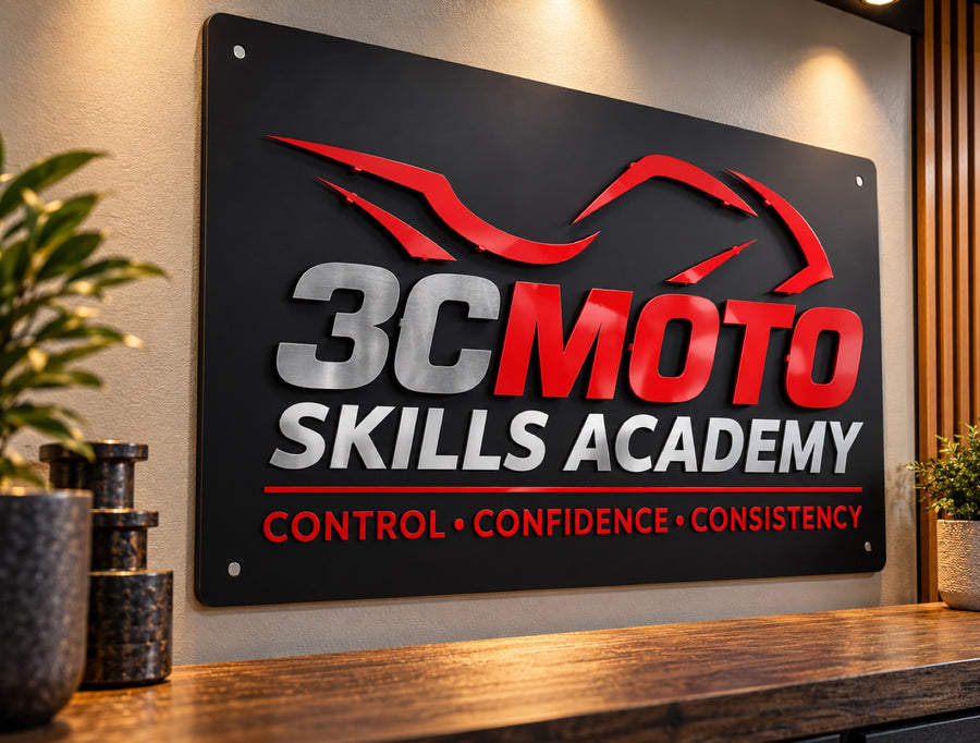 Dimensional metal business sign for 3C Moto Skills Academy with raised red and brushed metal lettering and a layered motorcycle graphic on a black panel