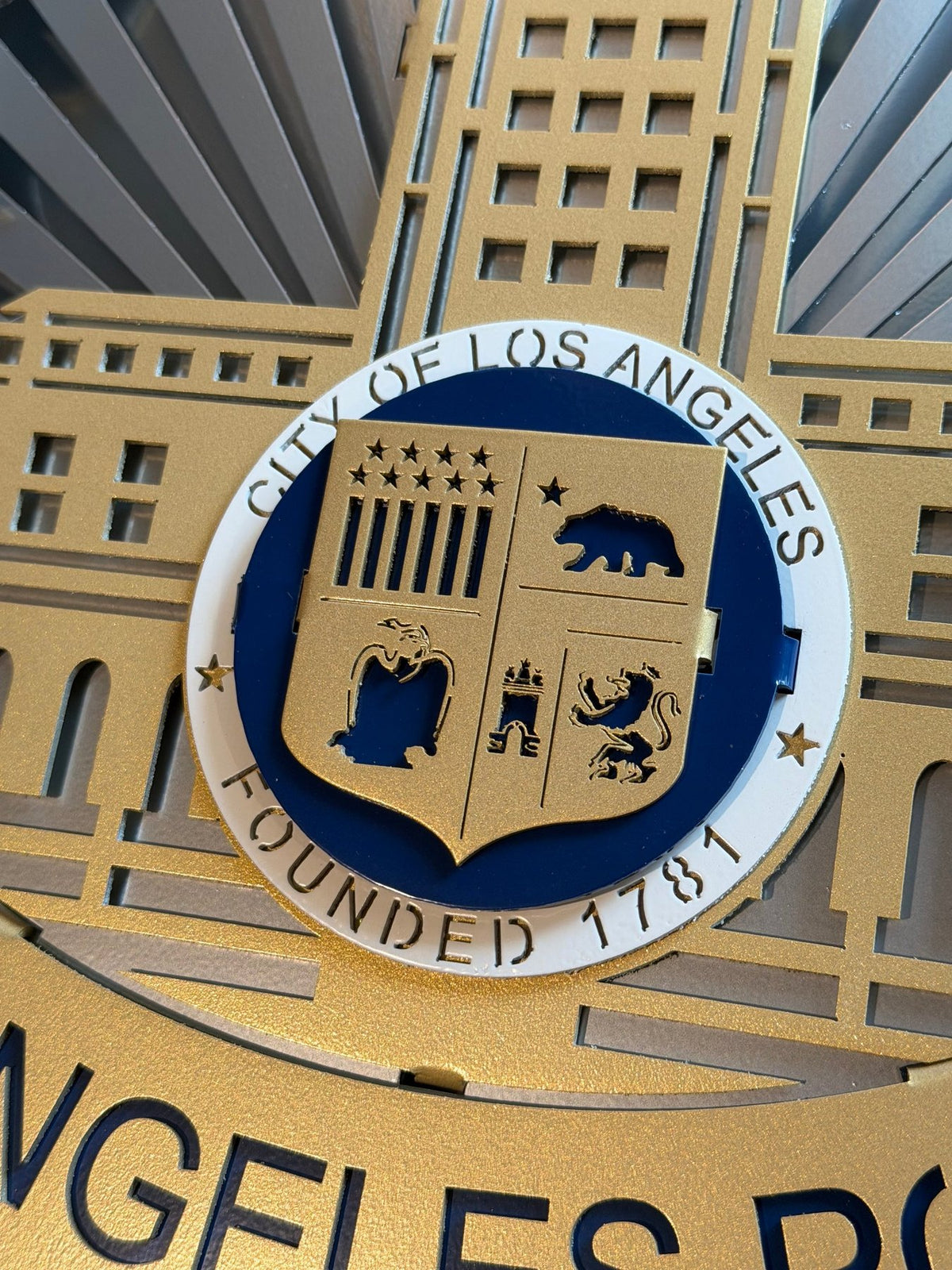 Close-up of city seal and raised building layers, Los Angeles Police Department Badge by IRONiNK.