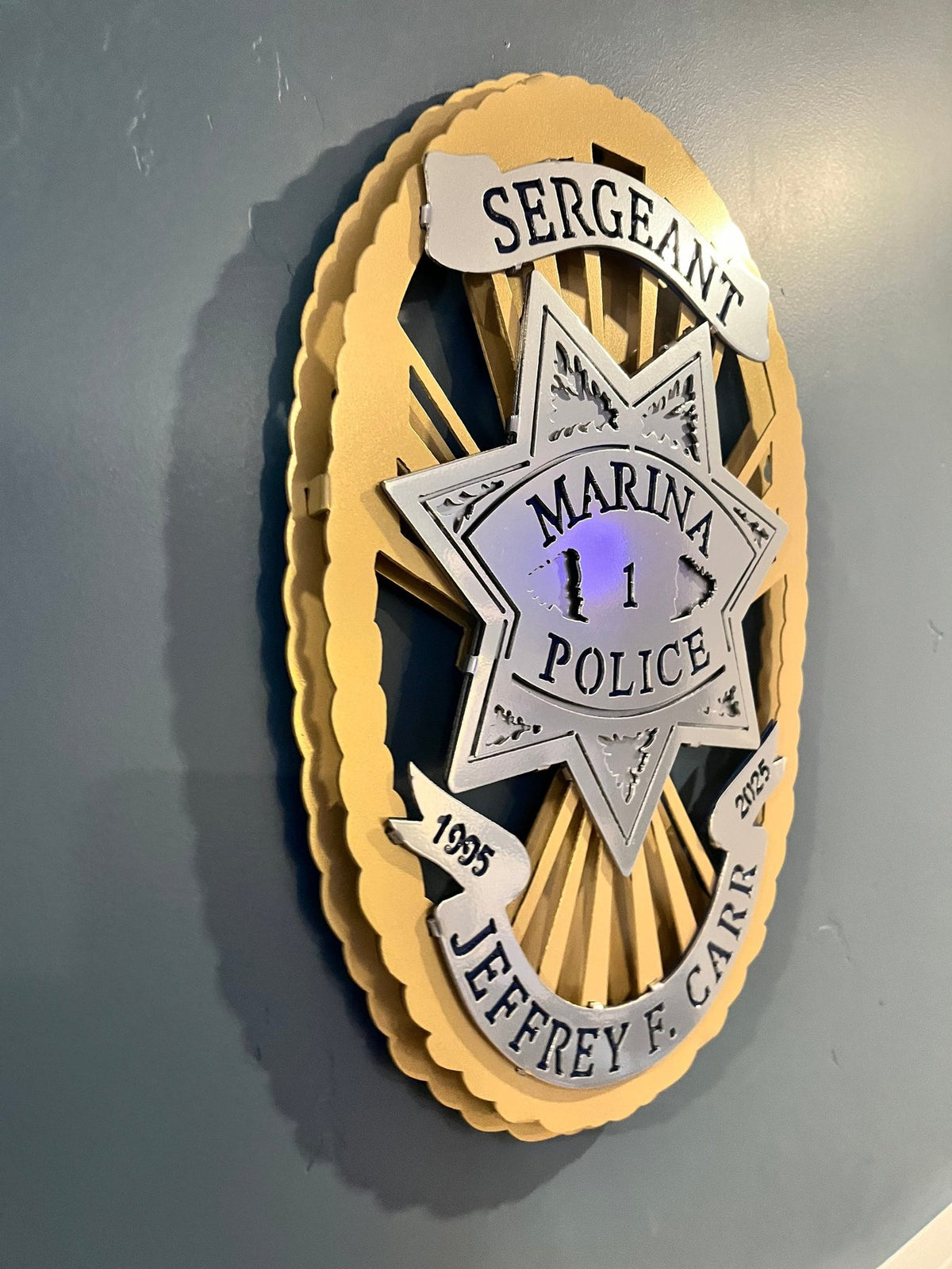 Side view of wall-mounted badge layers, Marina Police Department by IRONiNK.