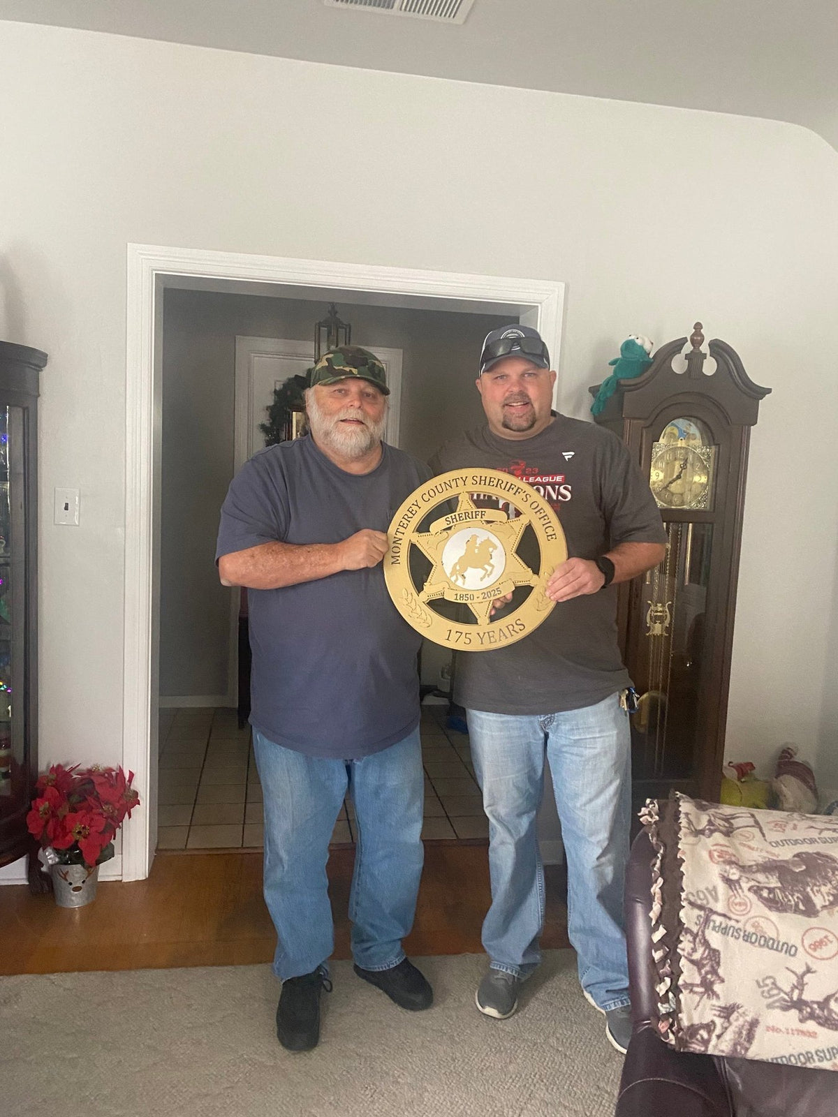 Two recipients holding an anniversary sheriff sign, Monterey County Sheriff Star by IRONiNK.