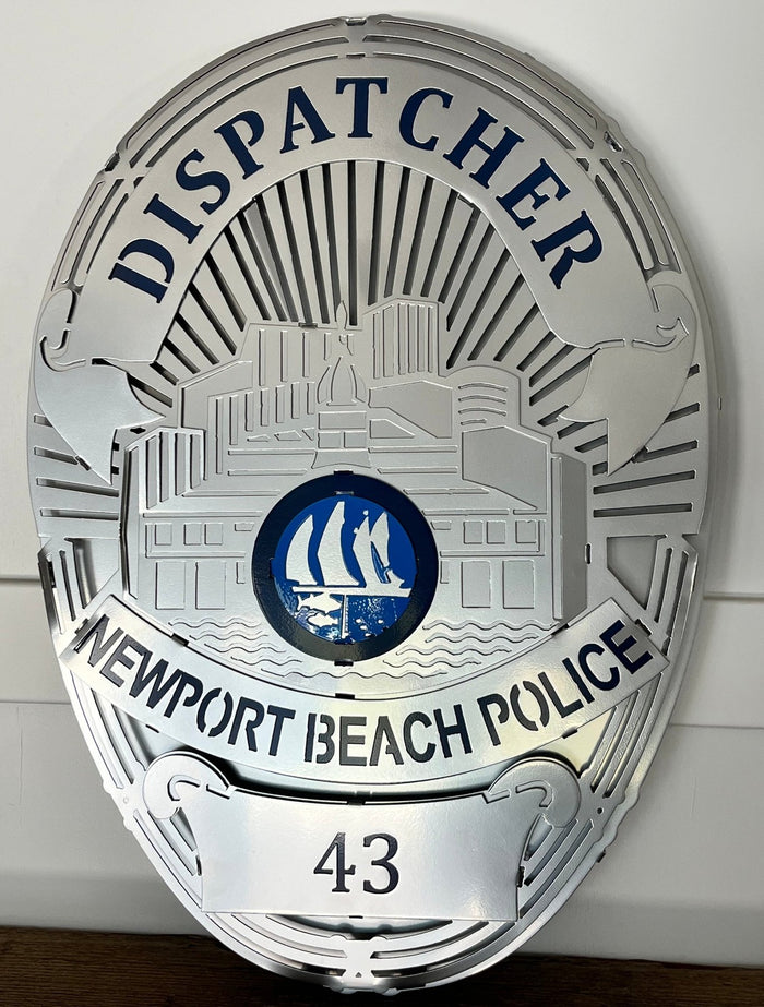 Close-up of dispatcher lettering and blue sailboat seal, Newport Beach Police Department Badge by IRONiNK.