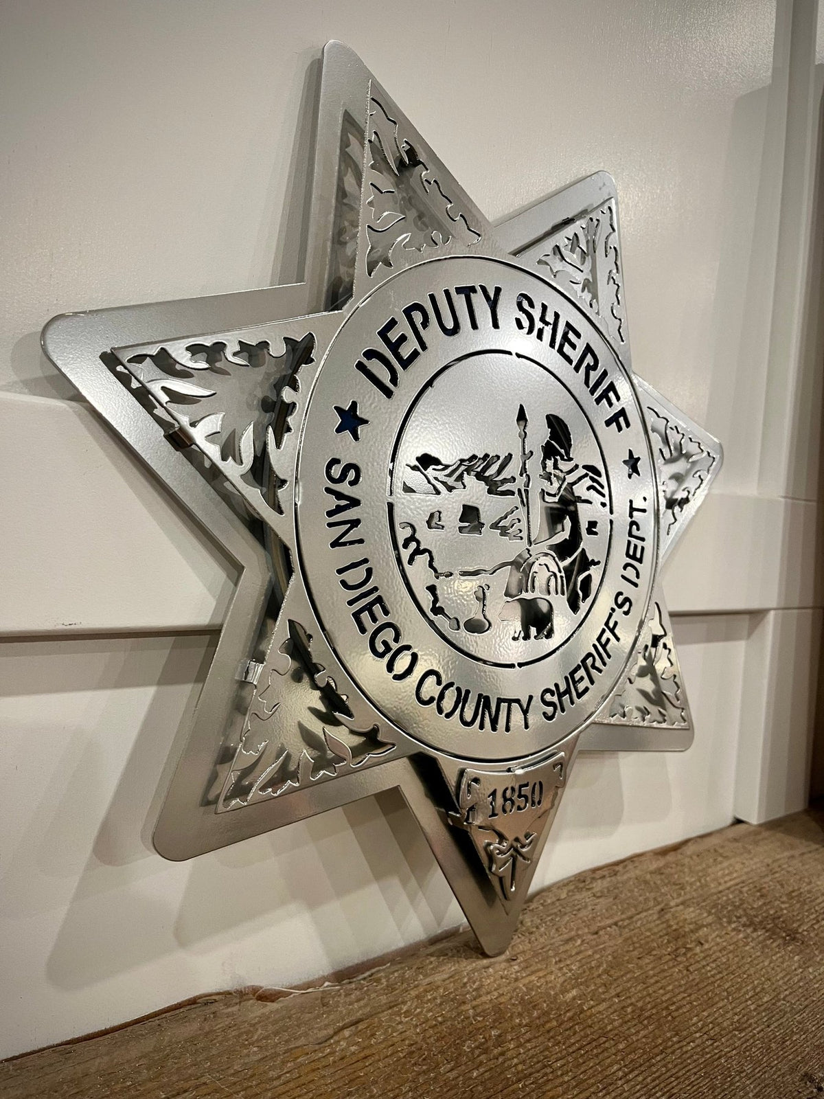 Silver deputy sheriff star on a wooden shelf, San Diego Sheriff Star by IRONiNK.
