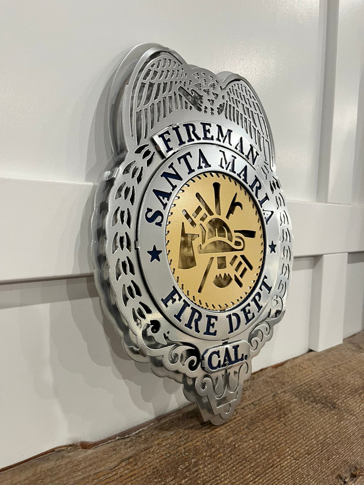 Retro silver fire badge on a wooden shelf, Santa Maria Fire Department (Retro Badge) by IRONiNK.