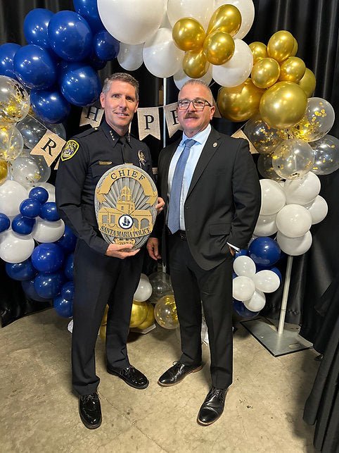 Two people presenting a personalized police badge sign, Santa Maria Police Badge by IRONiNK.