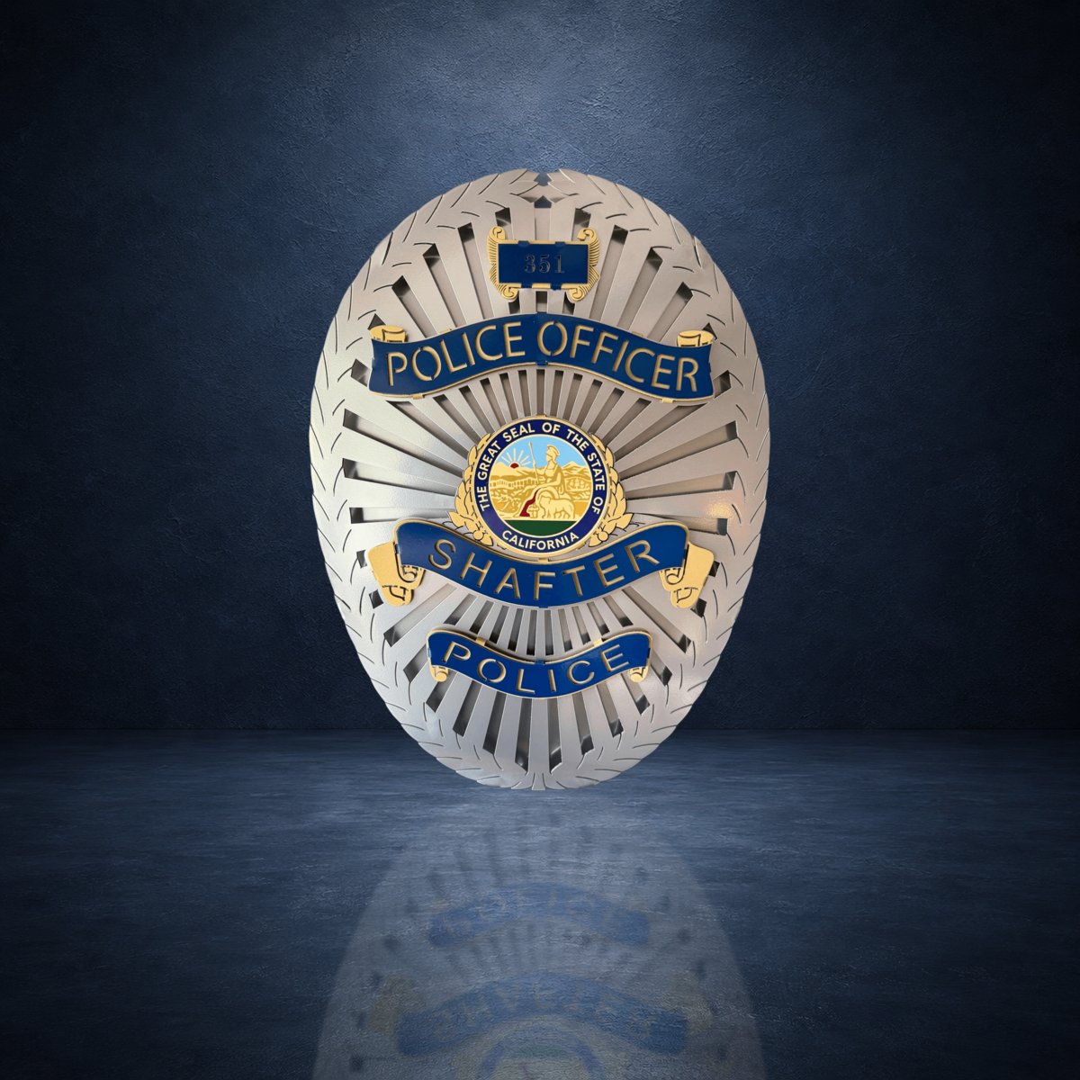 Badge against a dark blue studio background, Shafter Police Department by IRONiNK.