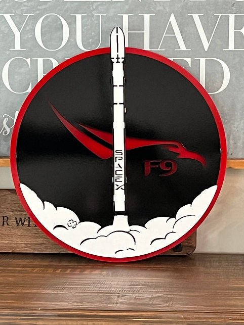 SpaceX Falcon 9: rocket sign displayed on a wooden shelf.