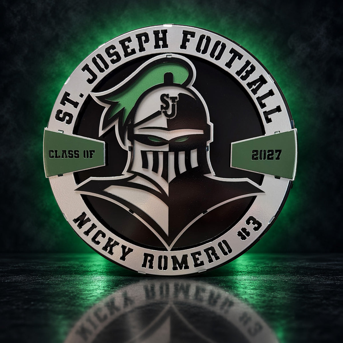 Front view of a personalized St. Joseph Knights layered metal display with a green studio glow