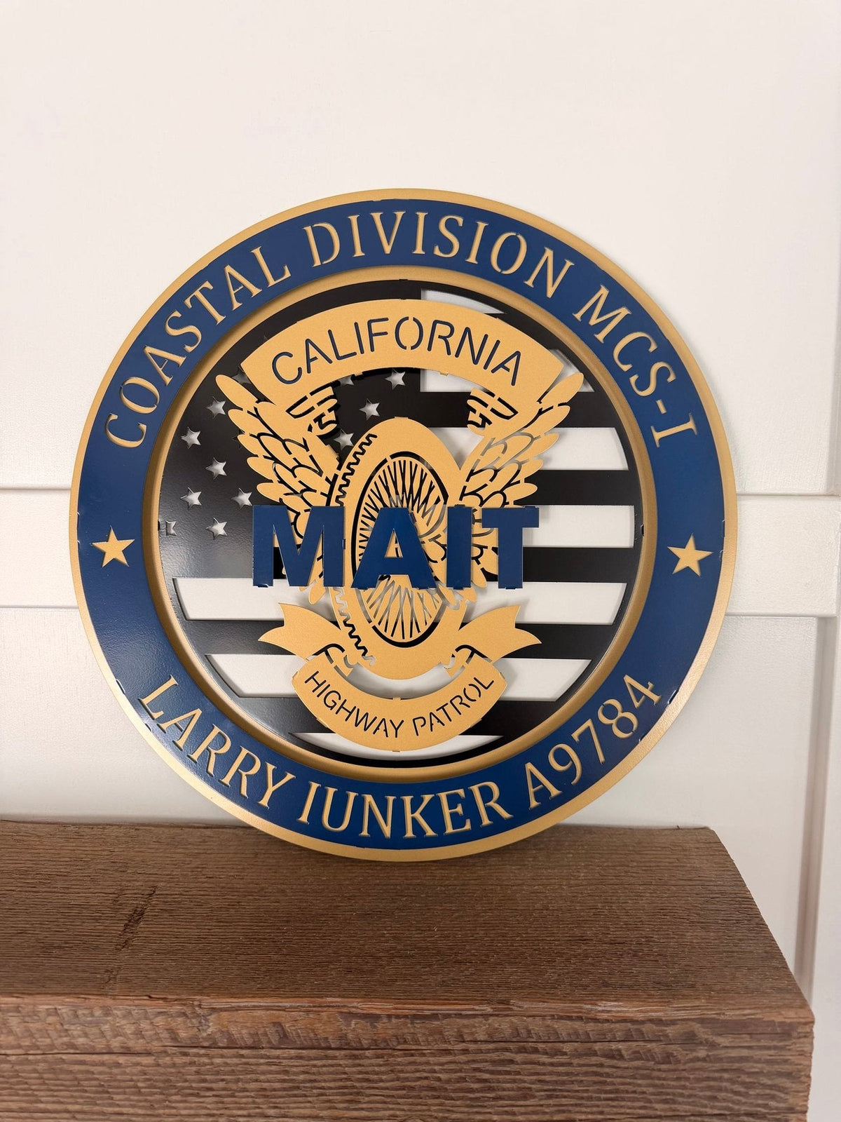 Tribute Sign: Coastal Division MAIT retirement tribute on a wooden shelf.