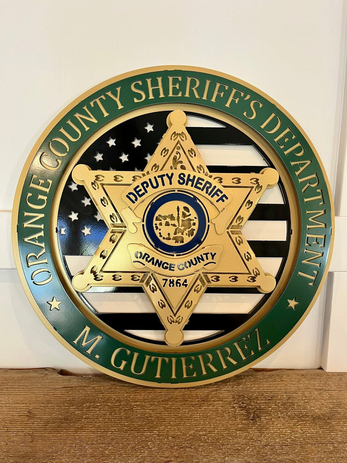 Tribute Sign: Orange County sheriff tribute on a wooden shelf.