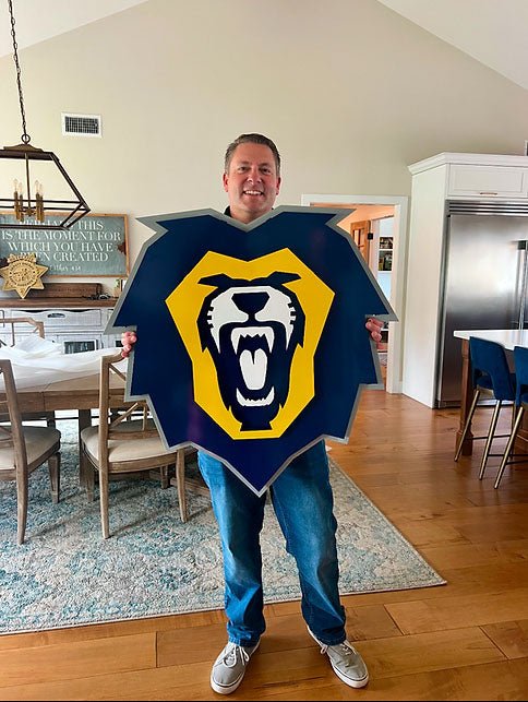 Recipient holding the lion emblem for scale, Vanguard University Lion by IRONiNK.